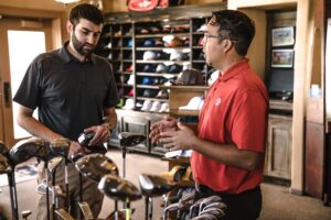retail-golf-shop-two-men-discussing-golf-clubs