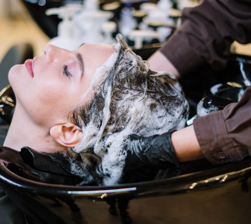 woman-getting-hair-washed-salon-facing-left